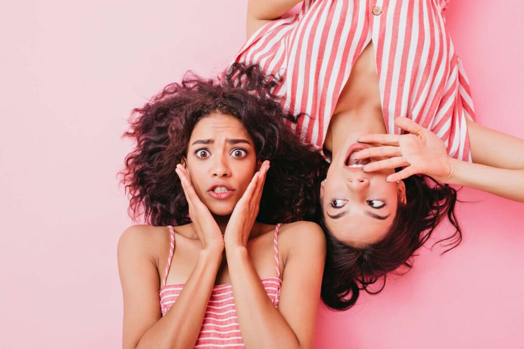 Worried stressed girl on pink background