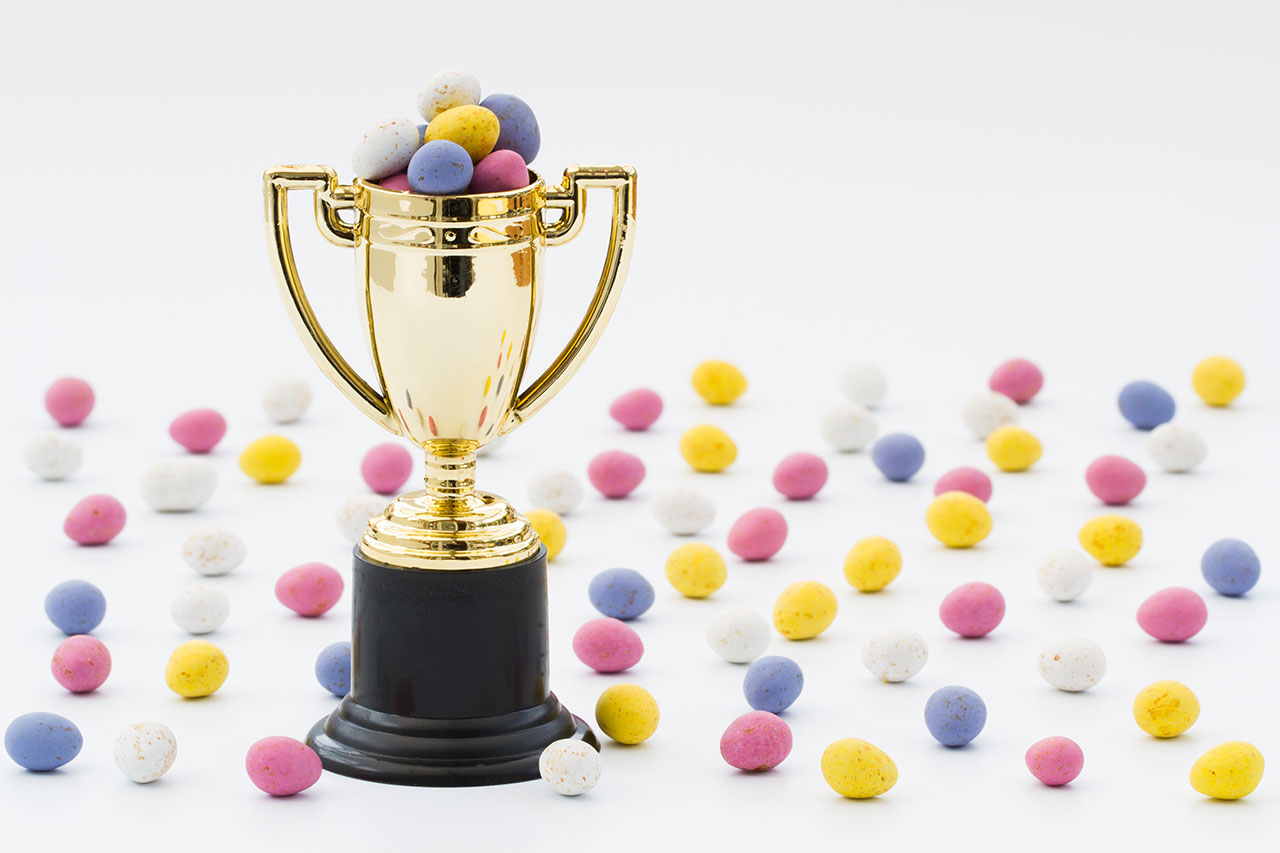 Trophy with chocolate eggs scattered around